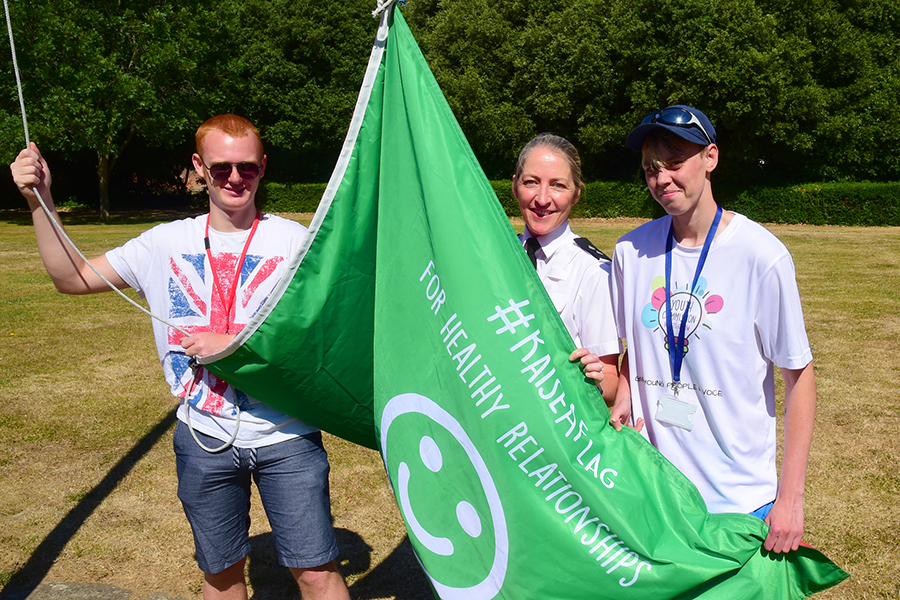 Youth Commission members and a police officer with a flag at Netley training headquarters