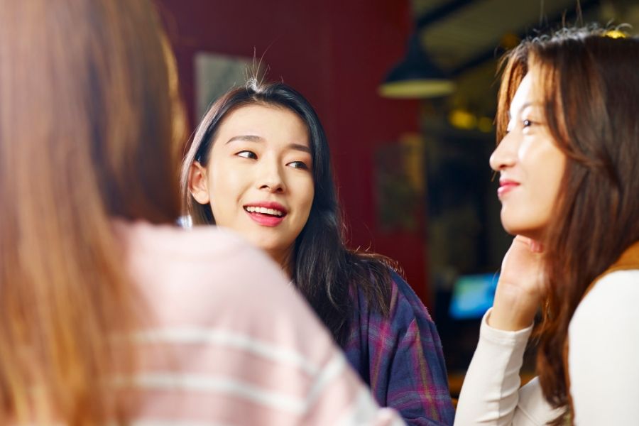 A group of young people smiling and talking