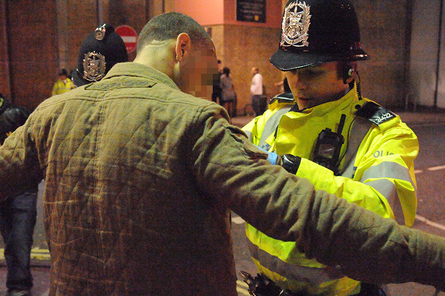 police officer searching a man