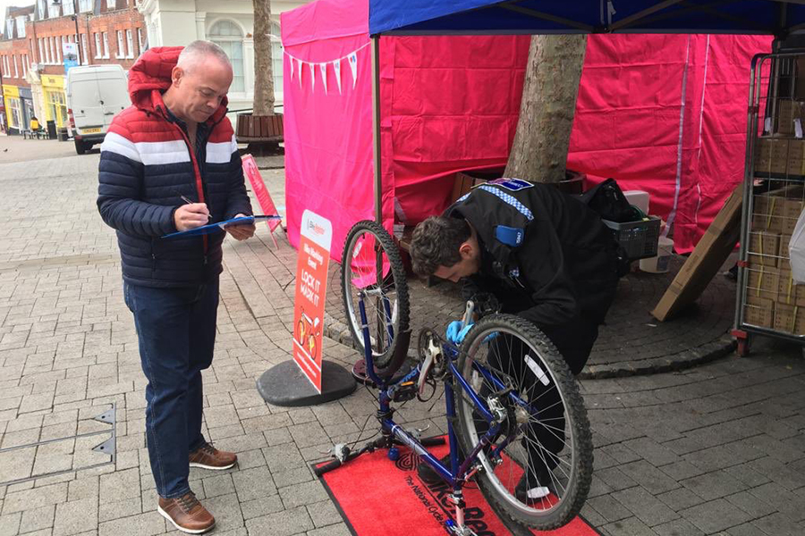 Cllr Simon Bound registering his bike with PCSO James.