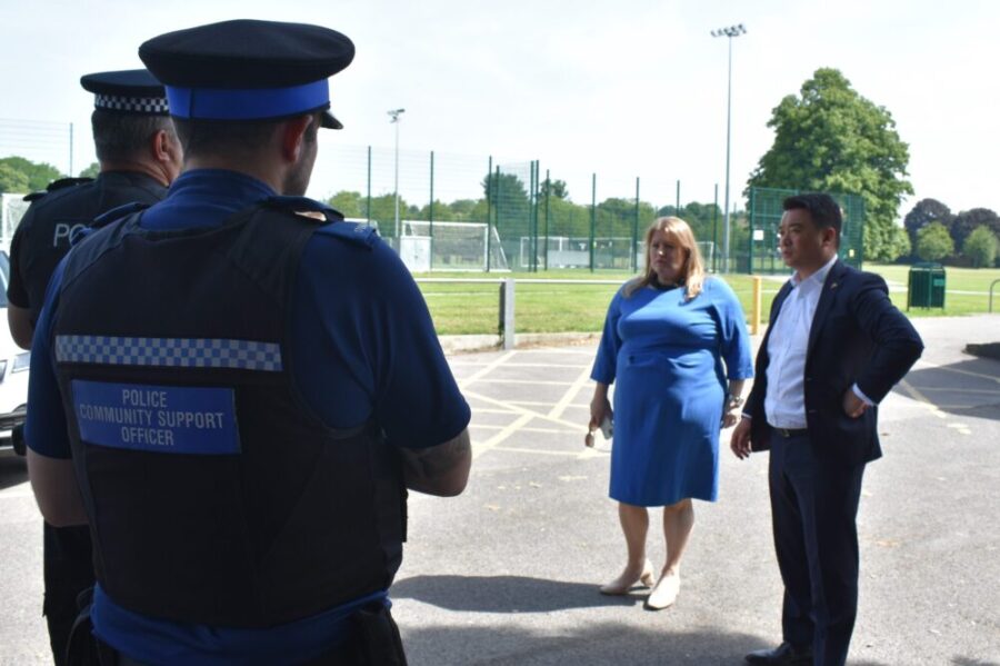 Donna Jones with Alan Mak MP speaking with officers outside in bright sunlight.