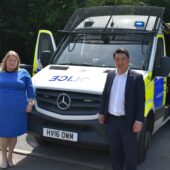 Donna Jones with Alan Mak MP standing in front of a police van looking happy