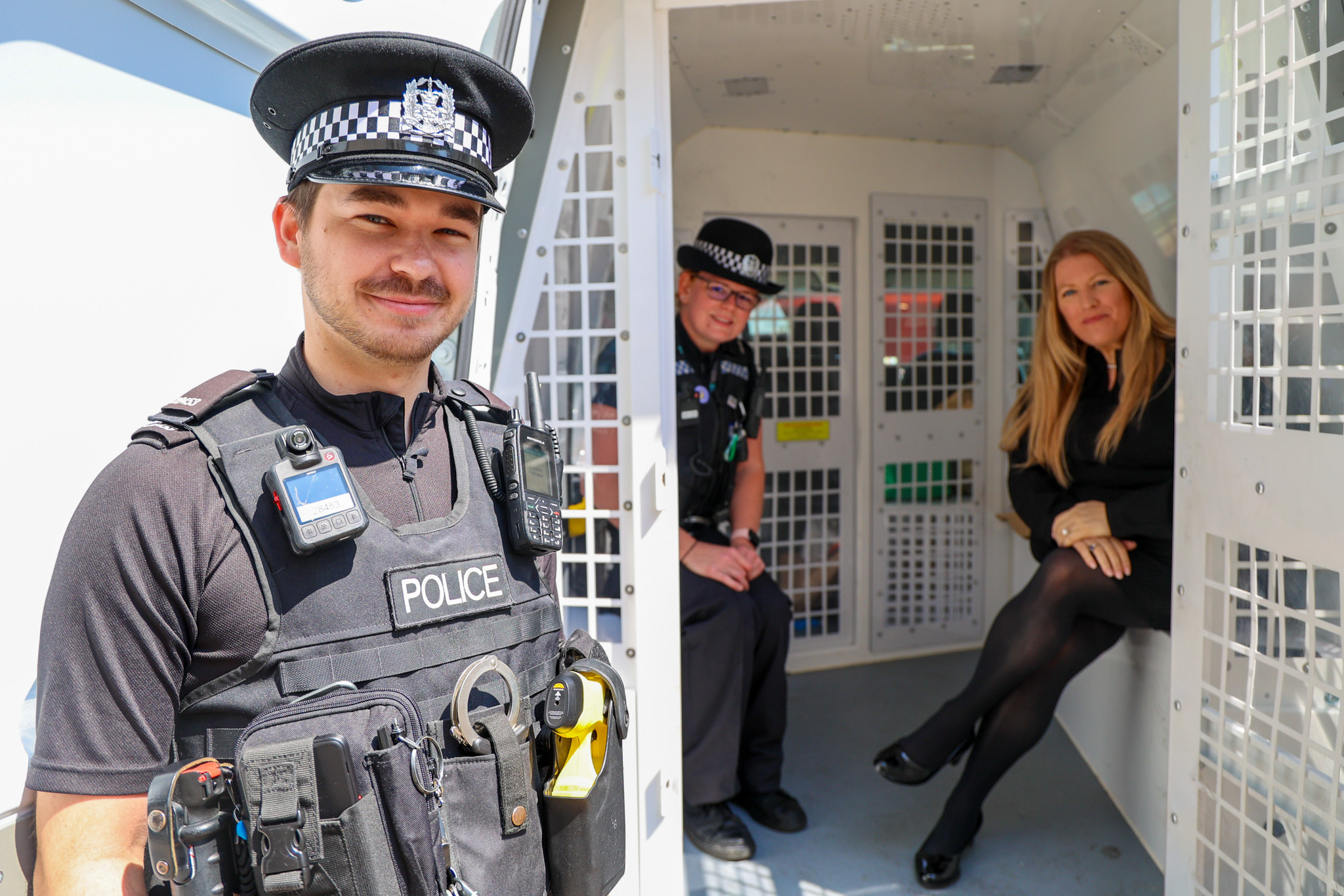 PCC Donna Jones in the back of a police van in Portsmouth with PC Pack in the van and PC Evans stood outside.