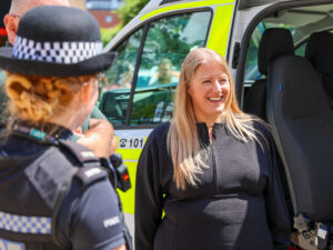 PCC Donna Jones standing in front of a police van with a police officer in Portsmouth.