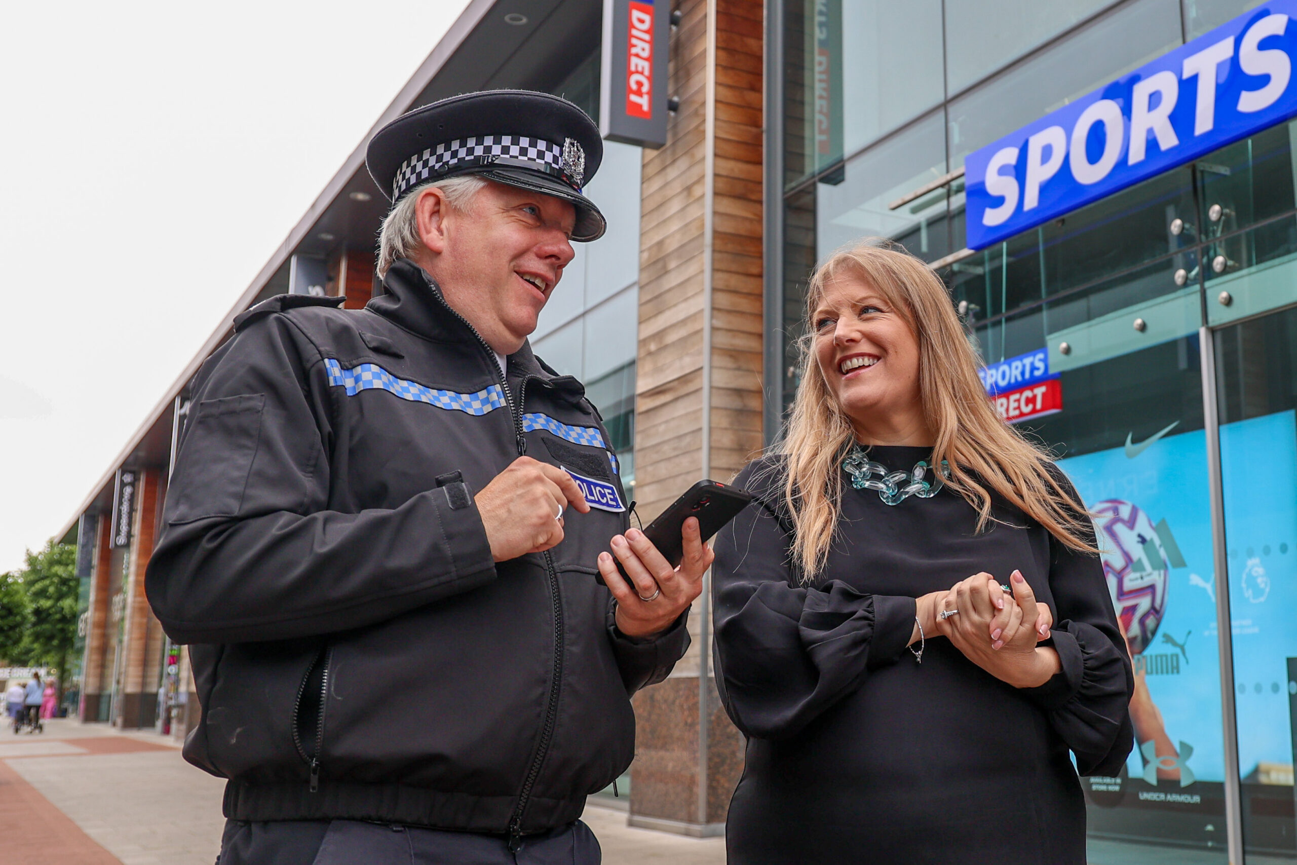 Chief Inspector Marcus Cator with PCC Donna Jones viewing the UKPAC app outside Sports Direct in Whiteley Shopping Centre
