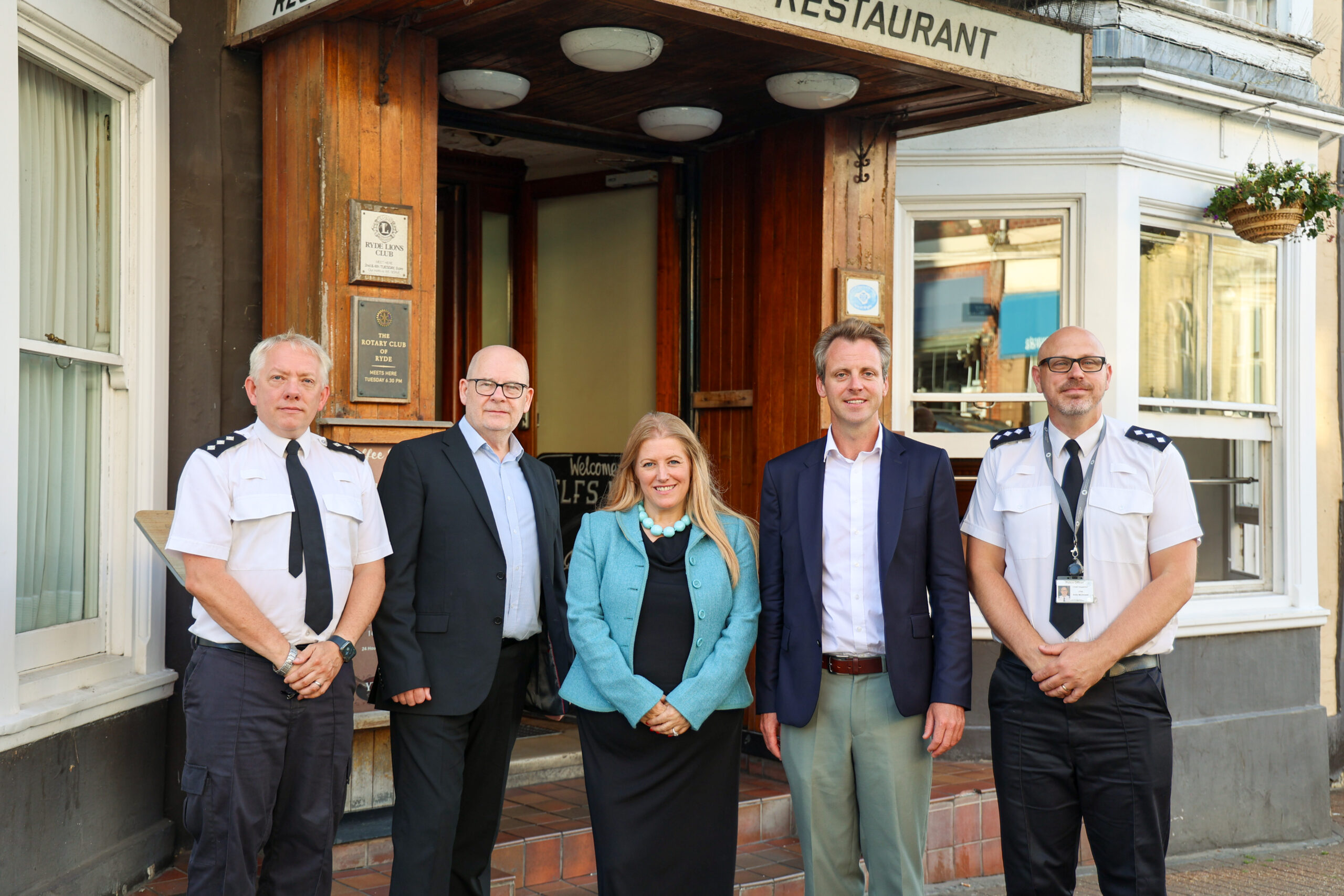 Police officers with PCC Donna Jones and Joe Robertson MP outside a hotel in Ryde