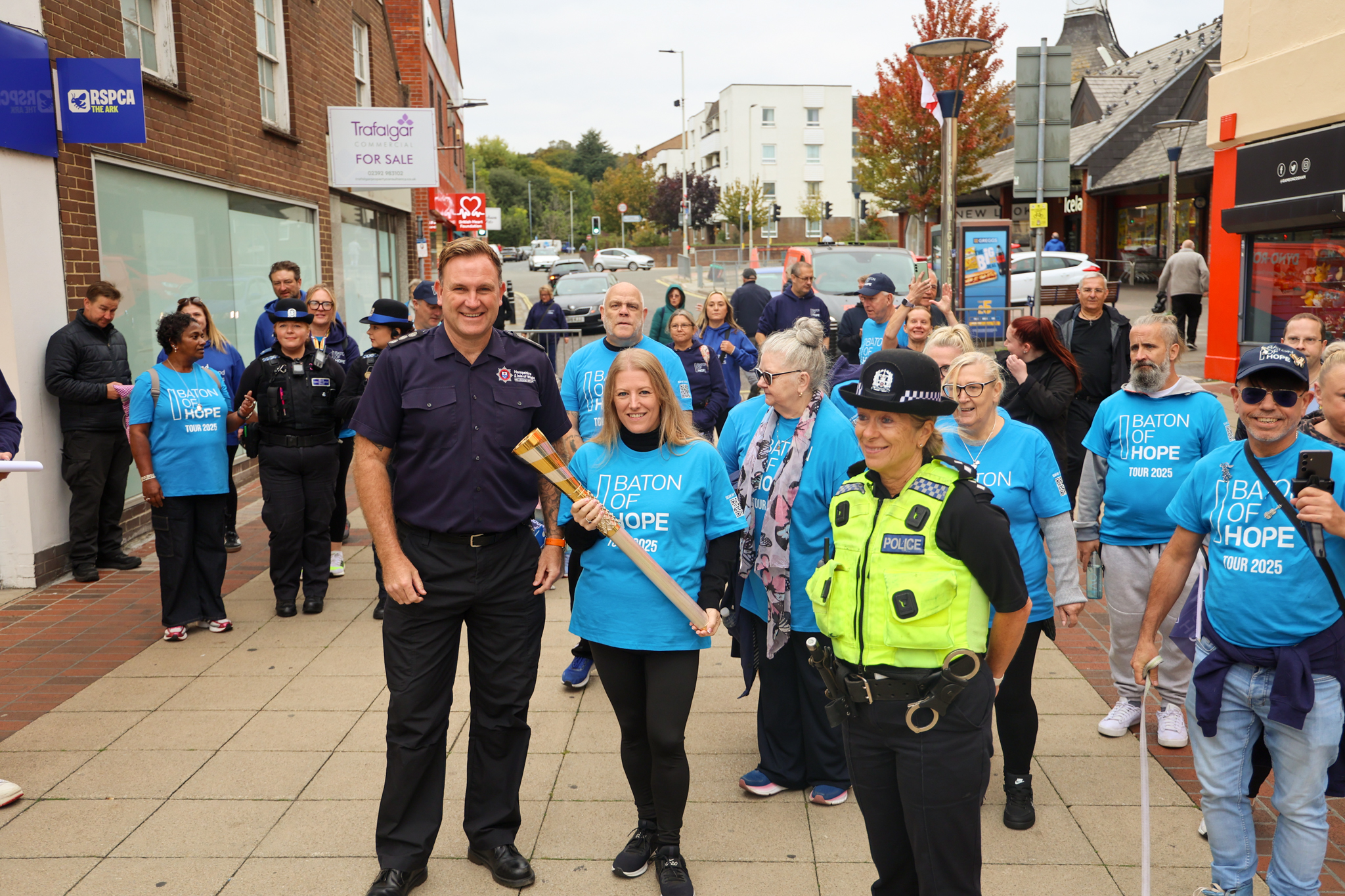 Stu Vince from Hampshire Fire & Rescue Service along with PCC Donna Jones carrying the baton of hope in Cosham High Street