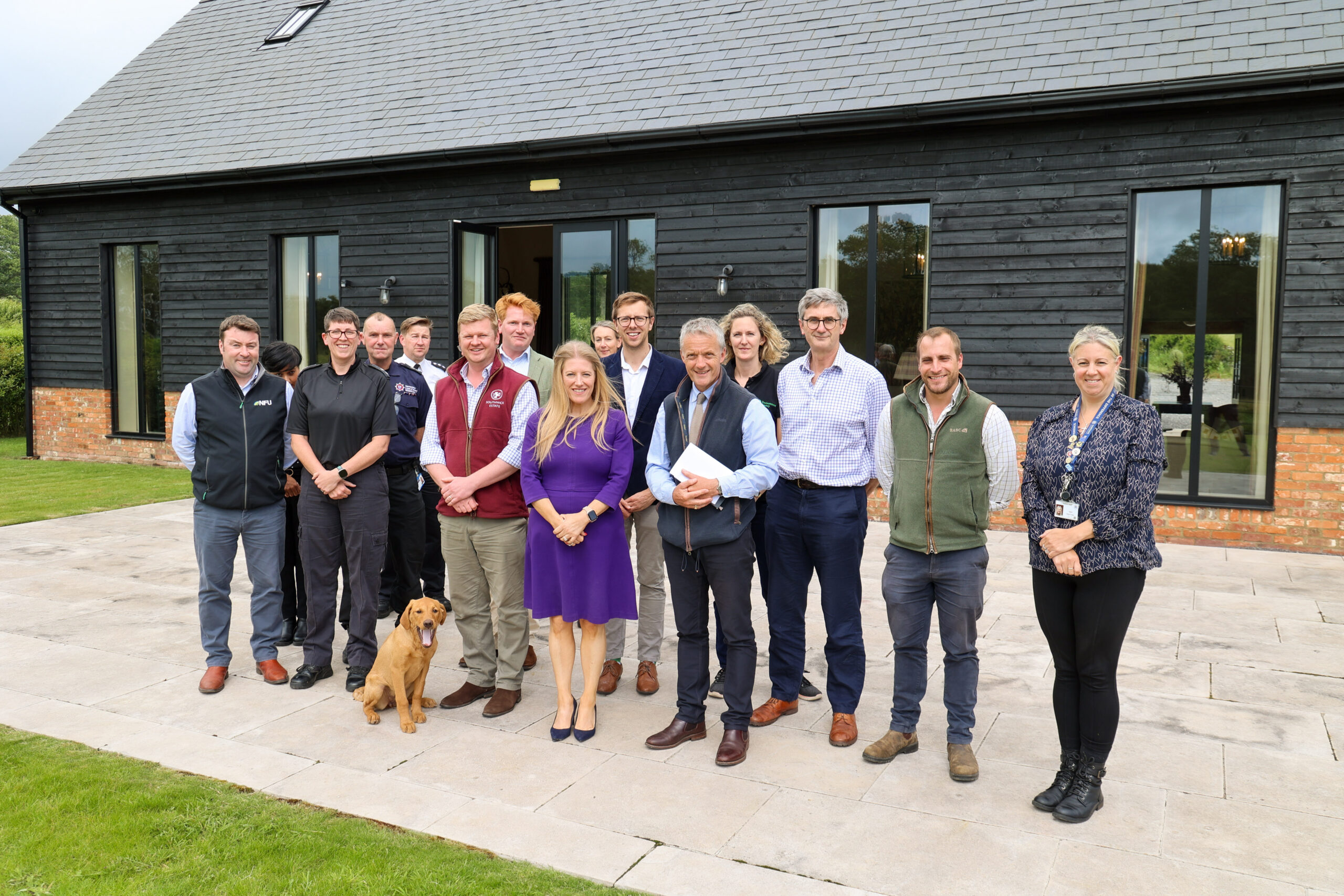 PCC Donna Jones stood outside a farm barn surrounded by attendees of a Rural Crime Meeting at Southwick Estate.