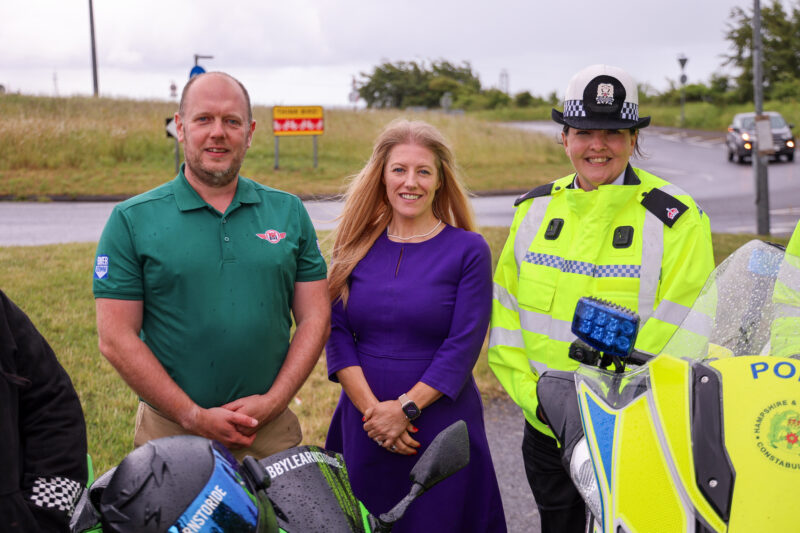 DocBike's Chris Wood, PCC Donna Jones and Acting Superintendent Emma Hart from the Roads Policing Unit stood next to a busy roundabout.