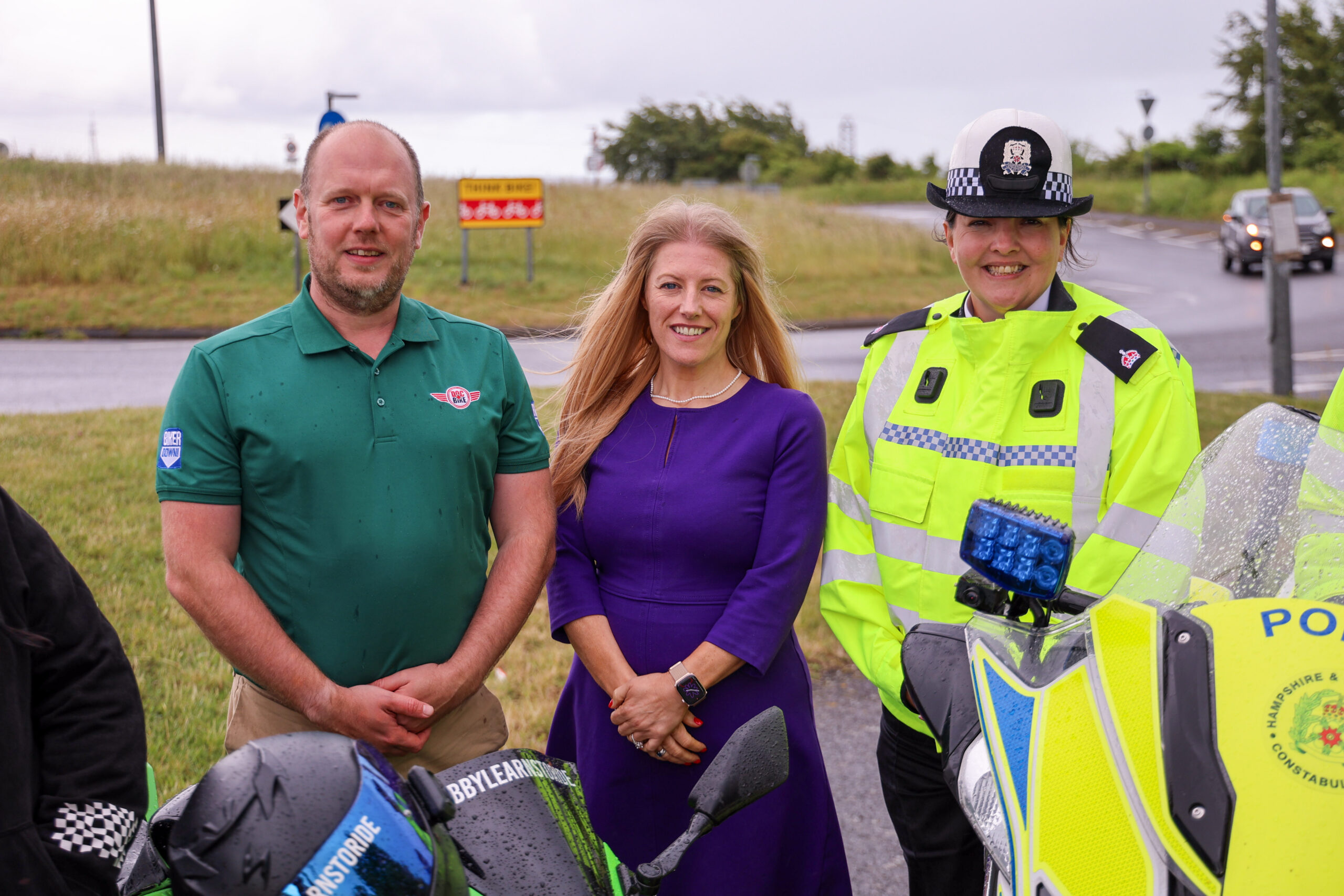 DocBike's Chris Wood, PCC Donna Jones and Acting Superintendent Emma Hart from the Roads Policing Unit stood next to a busy roundabout.