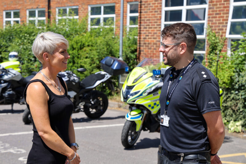 Emma Wilding and a police officer standing talking in front of police bikes