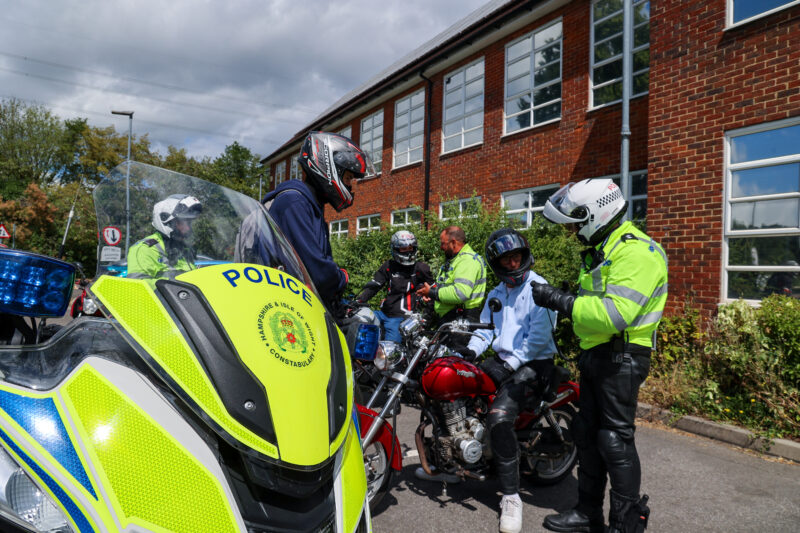 Police officer speaks to young motorcyclists