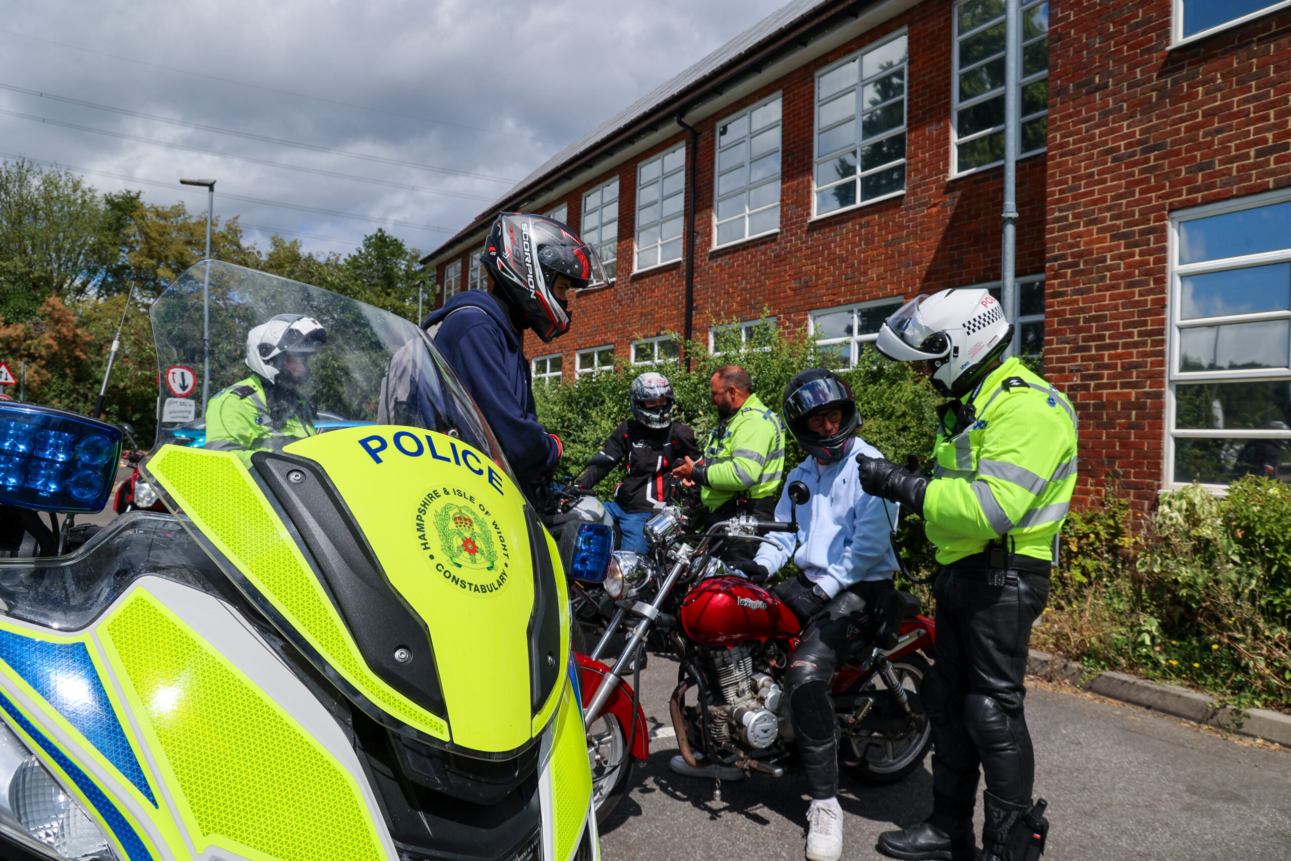 Police officer speaks to young motorcyclists