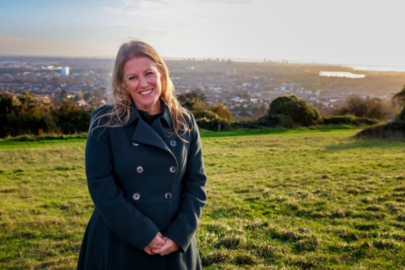 Donna Jones smiling in a green jacket on Portsdown Hill
