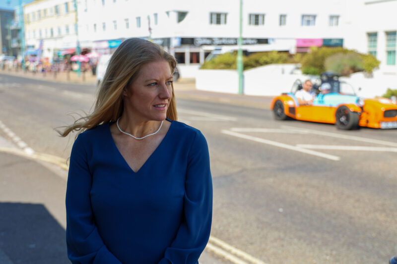 Donna Jones in a blue dress stood at the roadside