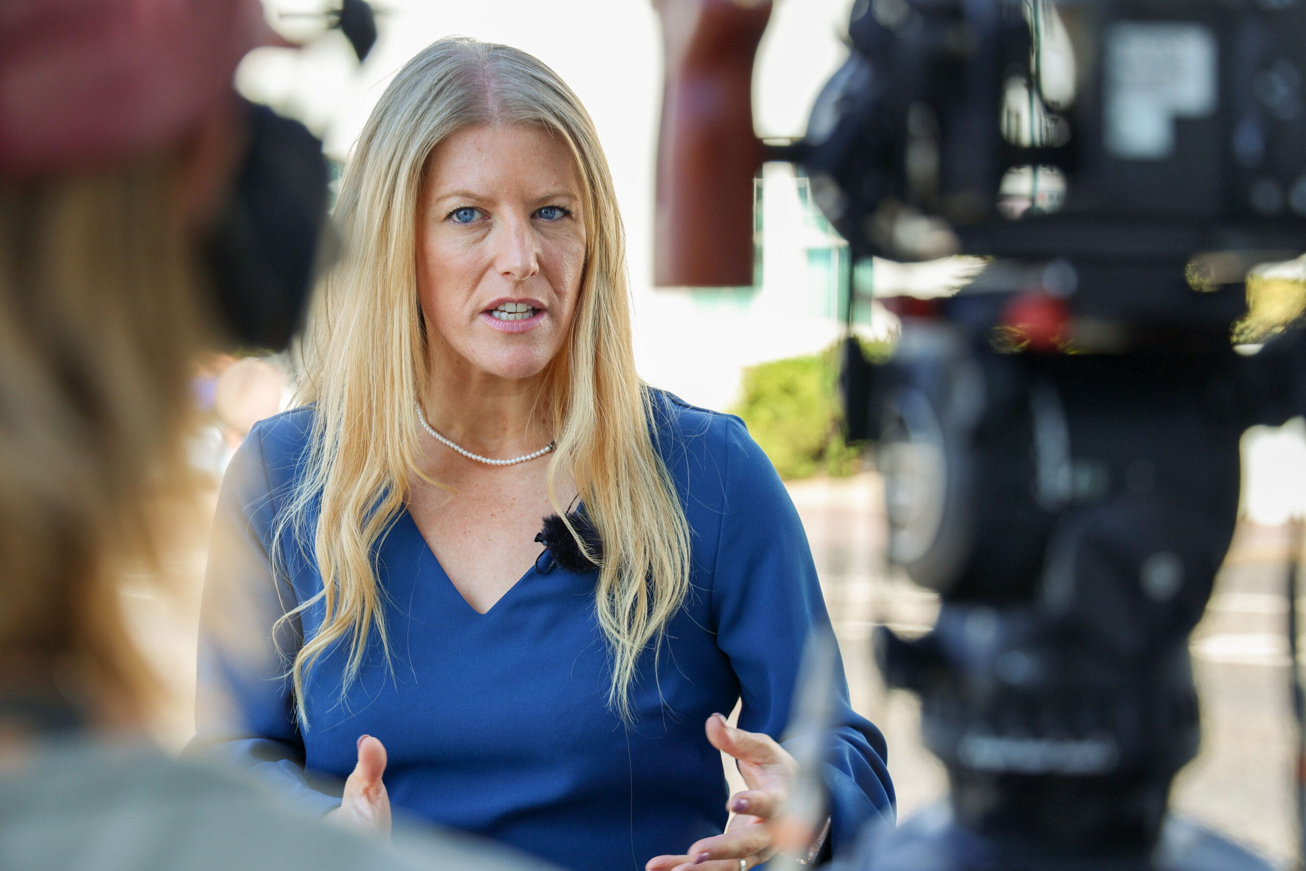 PCC Donna Jones talking to news media passionately in a blue dress