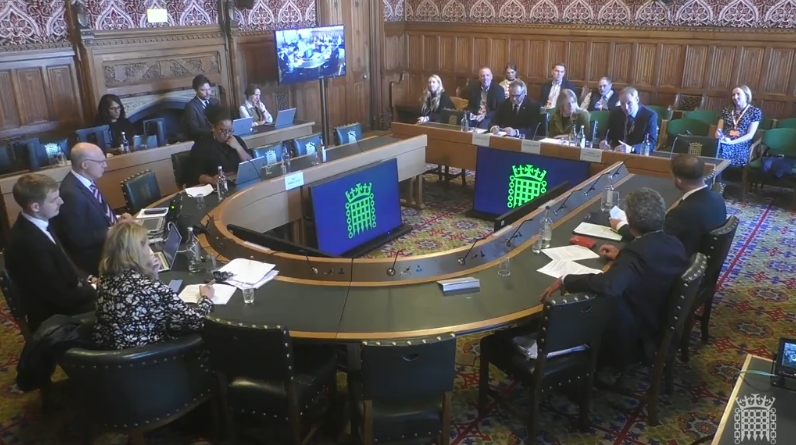 A wood panelled room at the House of Commons, where the Home Affairs Select Committee are sitting in session.